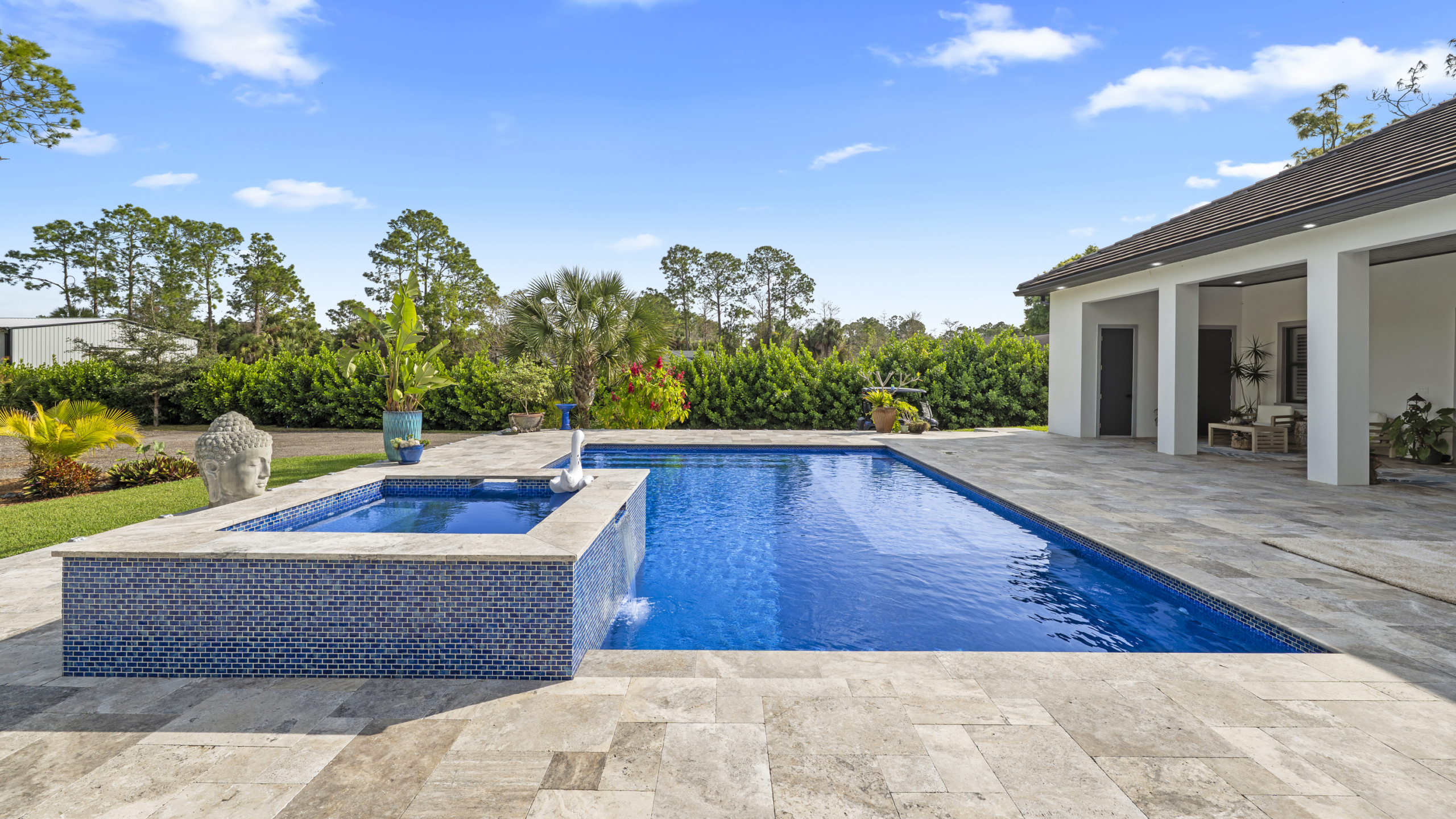 Luxury pool with spa in a Naples Florida home showcasing the relaxed lifestyle of Naples Florida real estate
