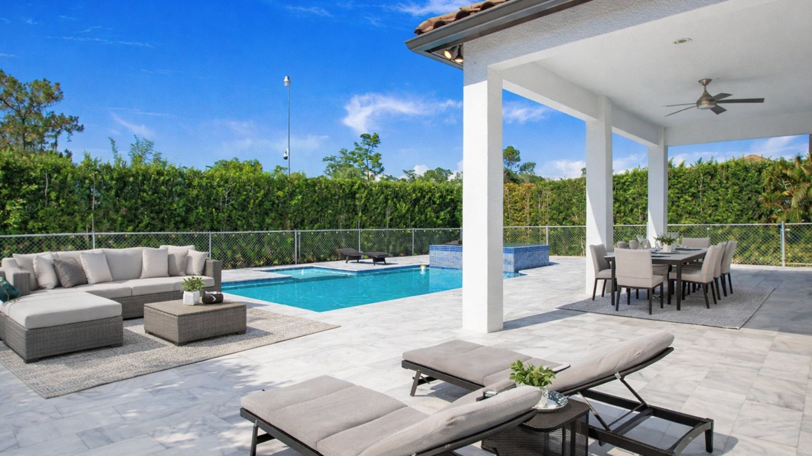 Private pool and covered lanai with lounge seating at 6341 Green Blvd, Golden Gate Estates, Naples FL