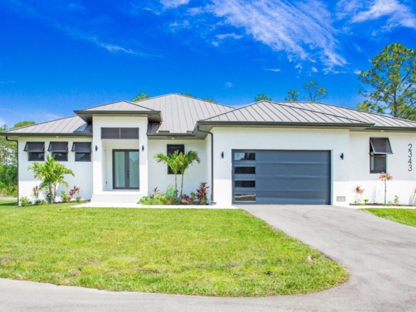 Newly built modern home with metal roof and two-car garage in Naples, Florida