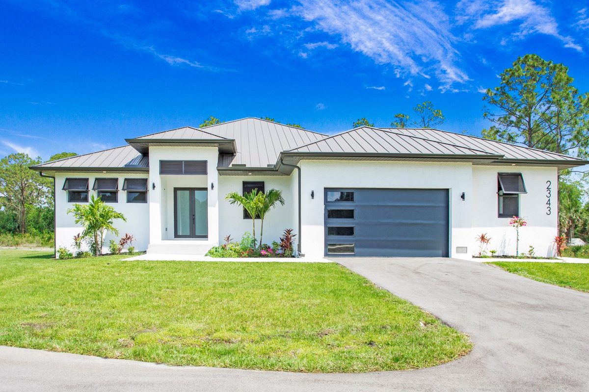 Newly built modern home with metal roof and two-car garage in Naples, Florida