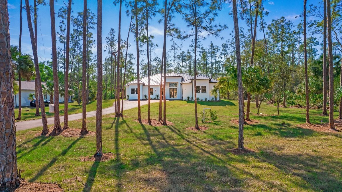 Home on a private wooded acreage lot surrounded by tall pines in Naples, Florida