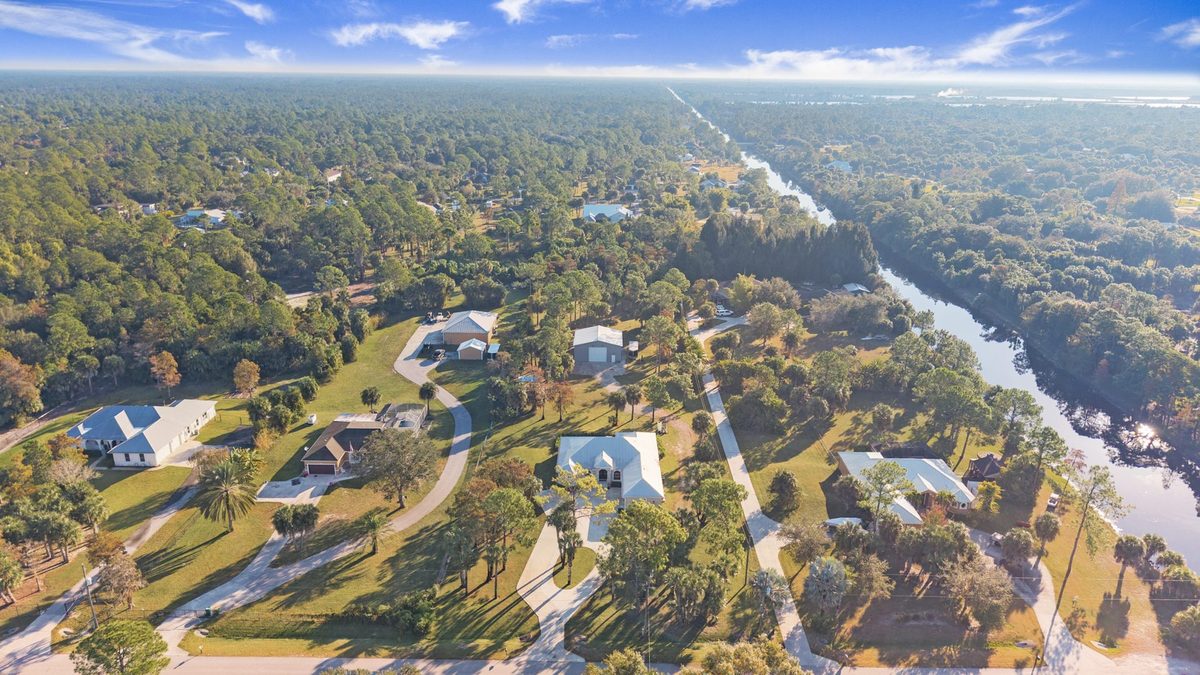 Aerial view of Golden Gate Estates acreage homes along a canal in Naples, Florida