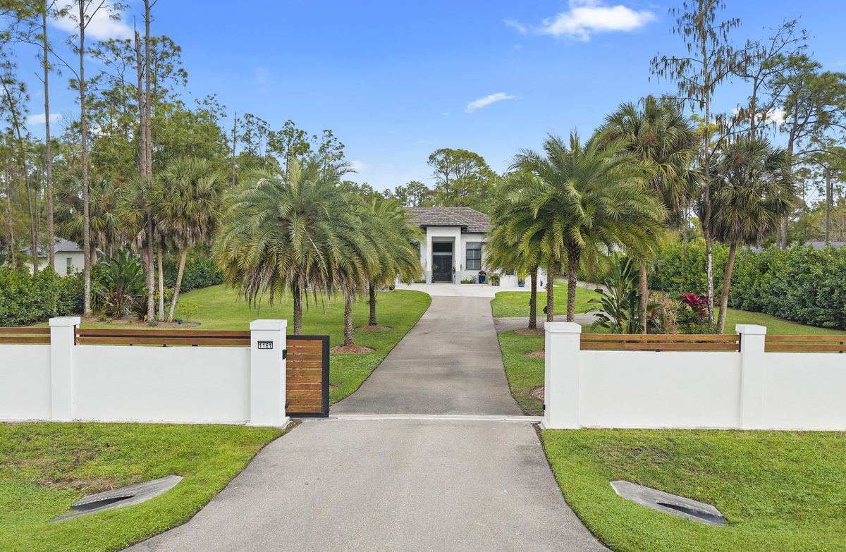 Gated estate home with palm-lined driveway in Naples, Florida