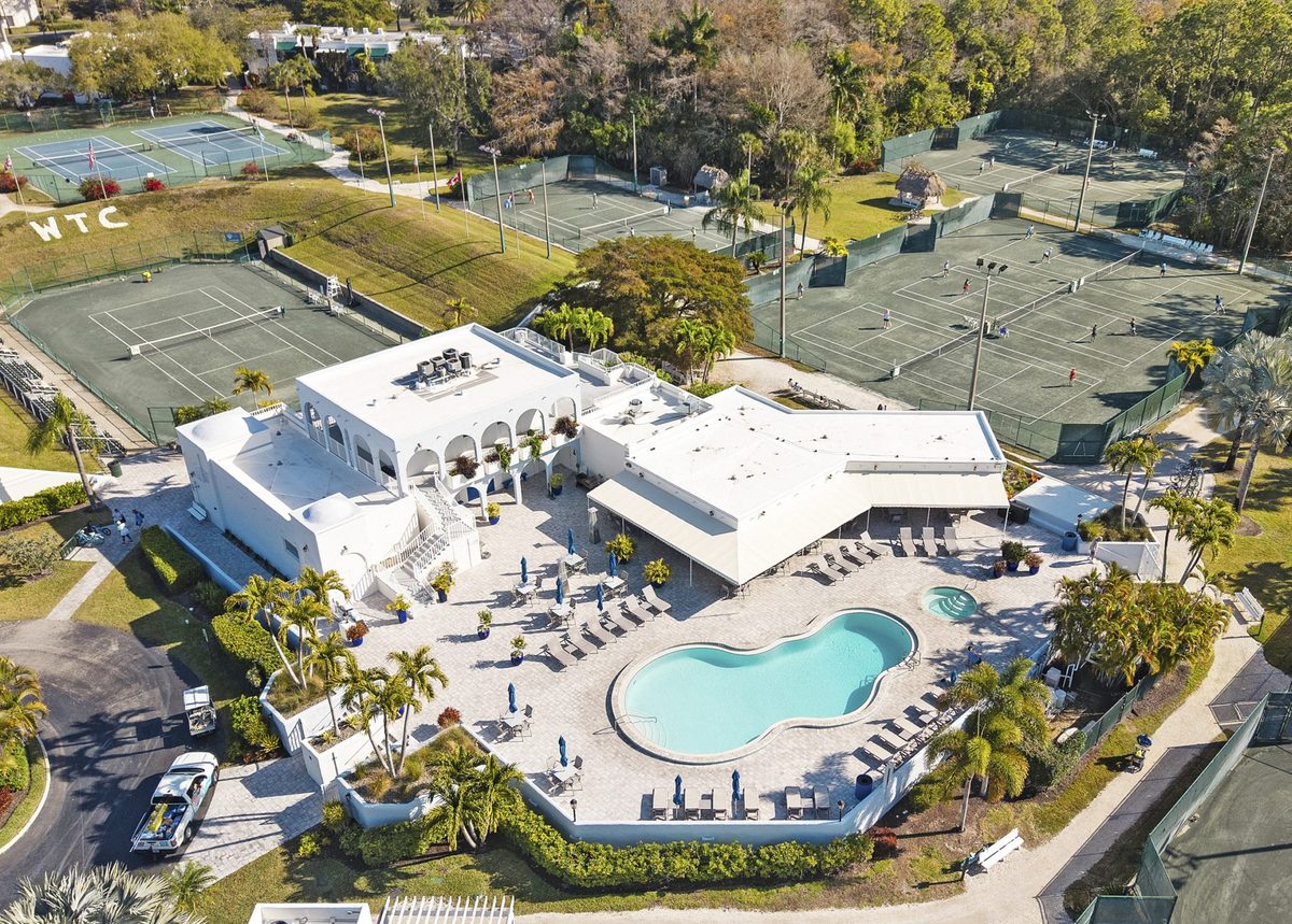 Aerial view of a Naples tennis club community with courts, clubhouse and swimming pool