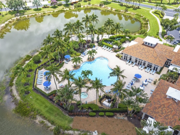 Aerial view of the lakeside resort-style pool and clubhouse at Bridgewater Bay in North Naples, Florida