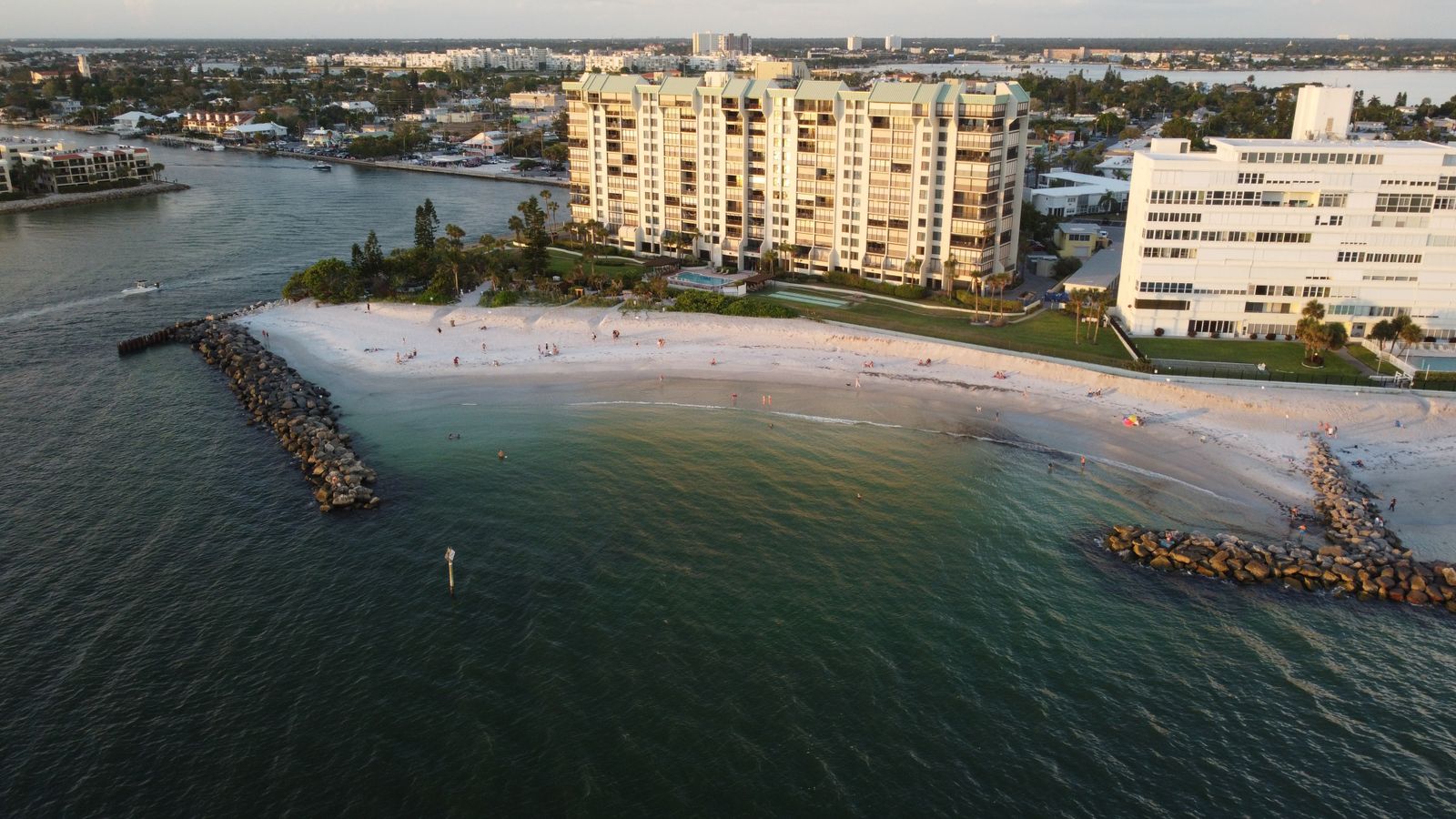 Beachfront condo towers on the white sand of the Naples, Florida coast — where the beach premium lives
