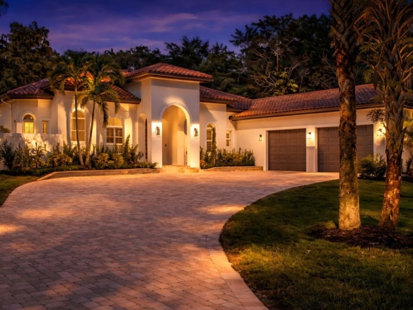 Naples, Florida home lit at twilight with paver driveway and palms — presentation drives the final sale price