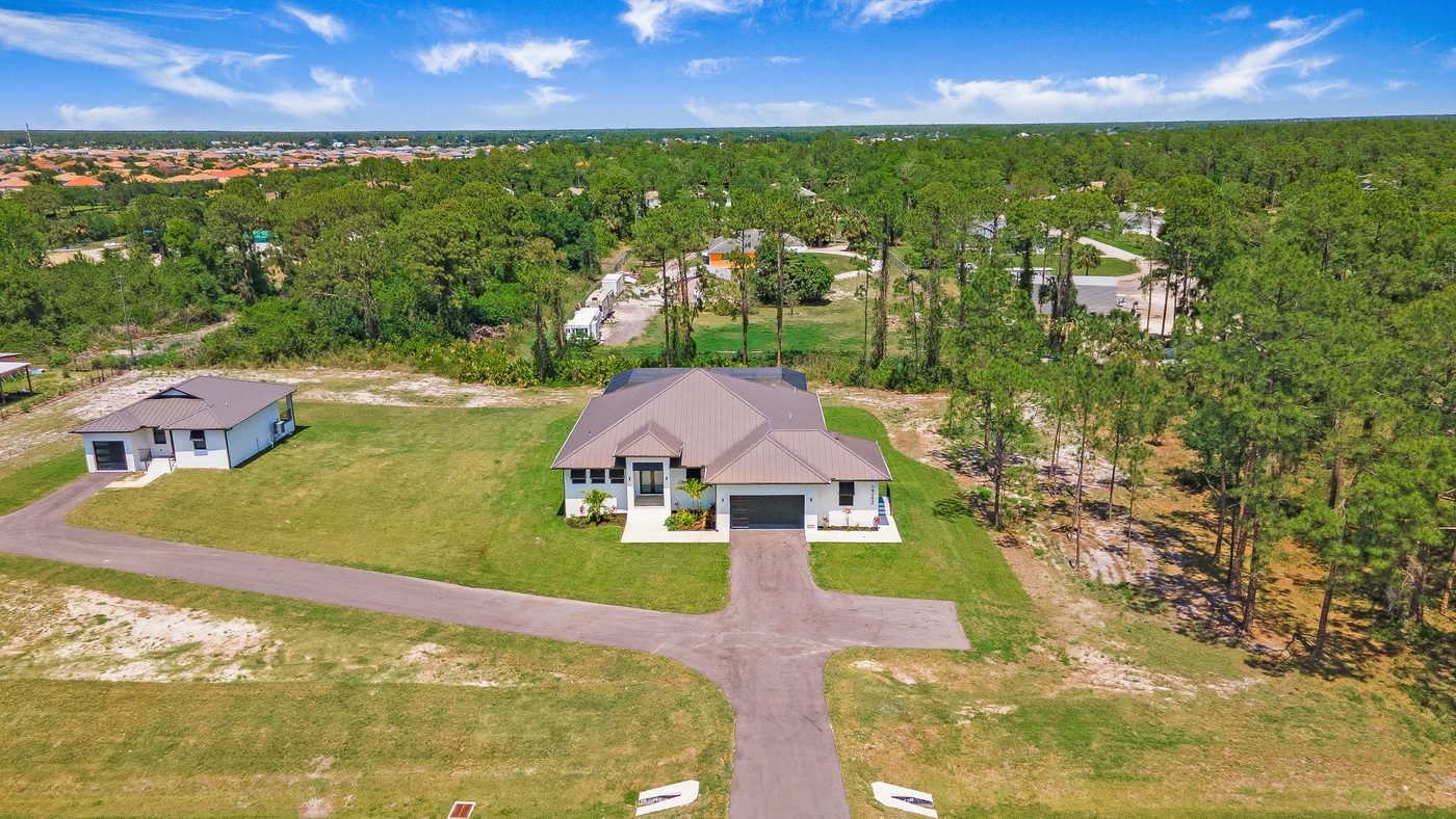 Aerial of a Golden Gate Estates home with a detached guest house on acreage in Naples, Florida