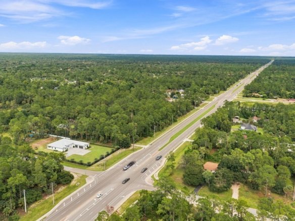 Aerial of wooded Golden Gate Estates acreage in Naples, Florida, with a new home on a 2.81-acre lot at 98 10th St NE