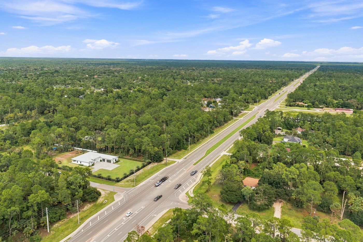 Aerial of wooded Golden Gate Estates acreage in Naples, Florida, with a new home on a 2.81-acre lot at 98 10th St NE