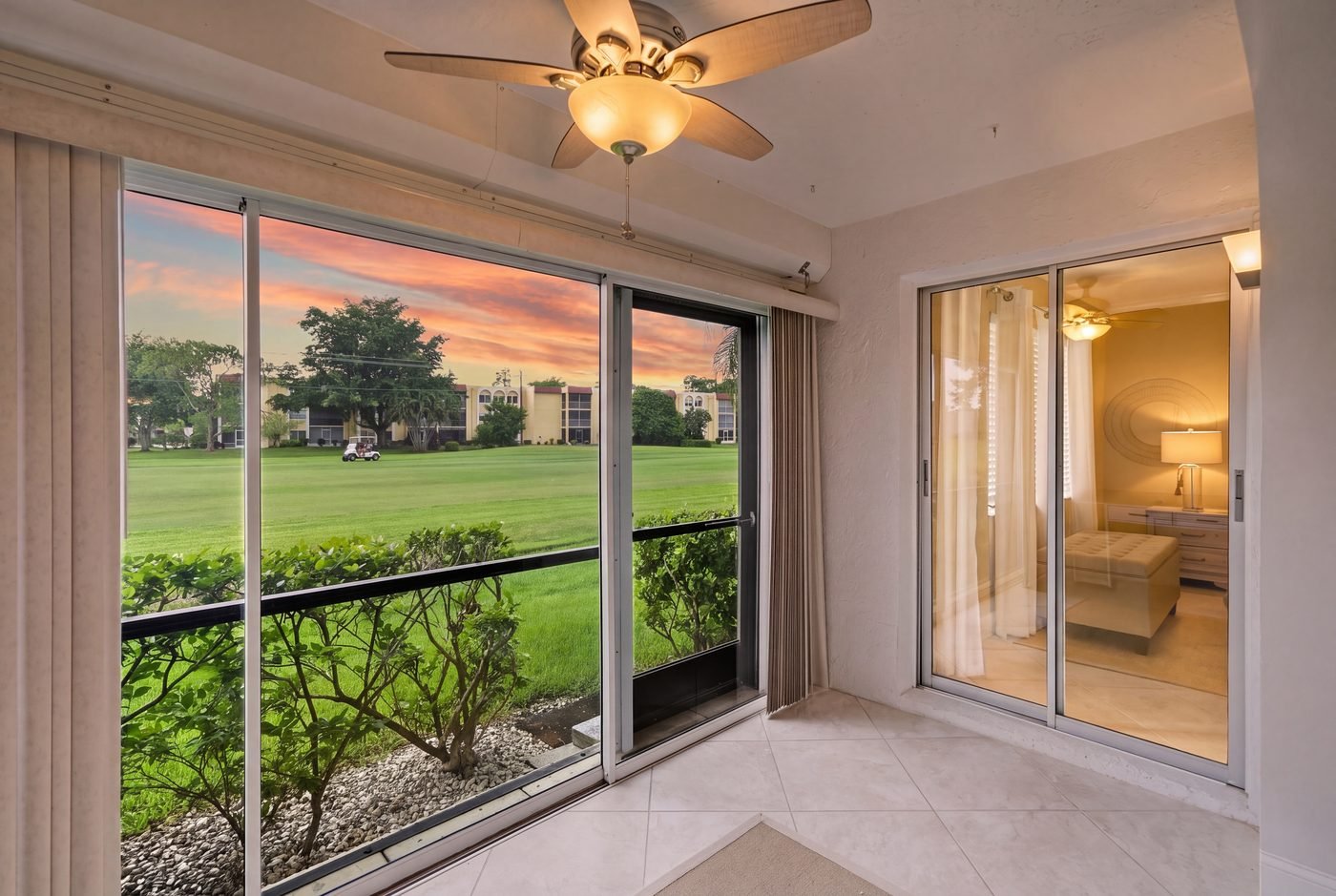 Glassed and screened first-floor sunroom with a sunset view over the Quail Run golf course in Forest Lakes, Naples, Florida