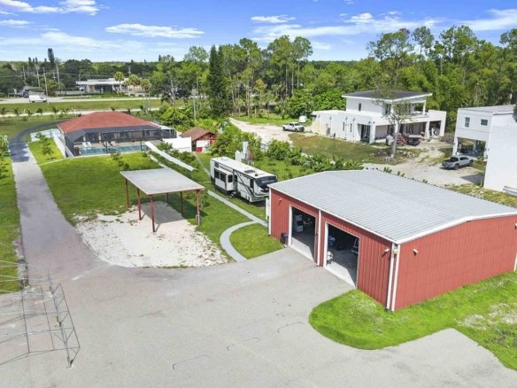 Aerial of a Golden Gate Estates home in Naples, Florida with a red 40 by 50 steel shop building and paved drive on 2.36 acres