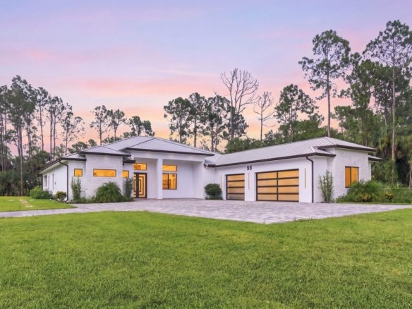 New construction home on 2.81 upland acres in Golden Gate Estates, Naples, Florida, at twilight