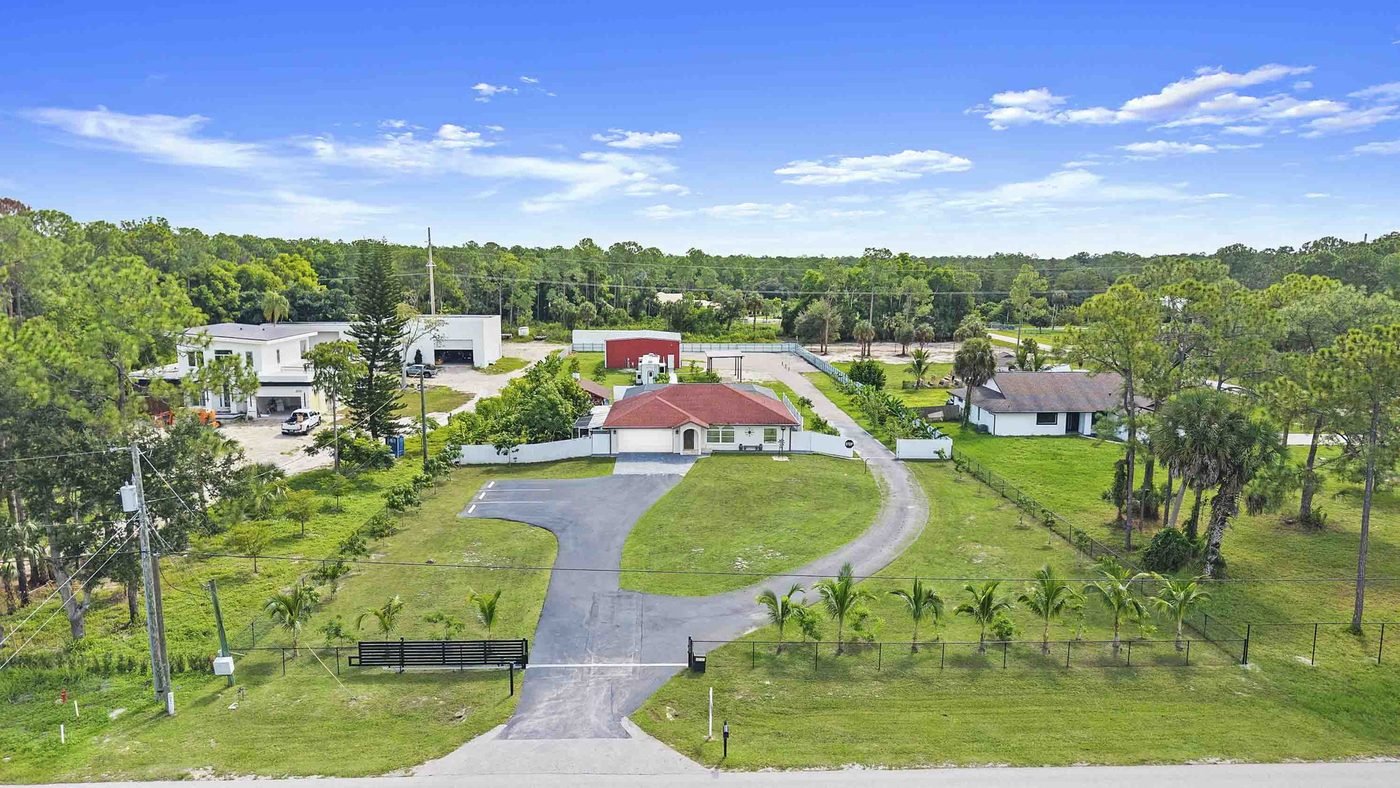 Aerial of a fenced and gated acreage home in Golden Gate Estates, Naples, Florida, the kind of lot horse owners look for