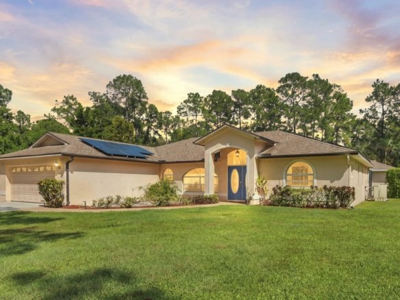 Golden Gate Estates home in Naples, Florida with rooftop solar panels at twilight