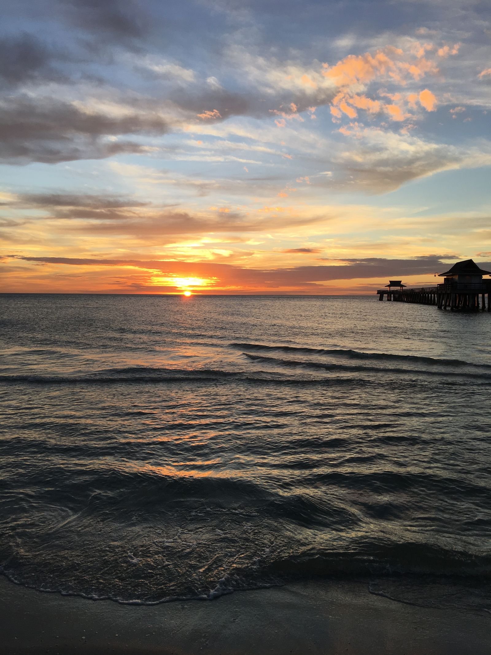 Sunset over the Gulf of Mexico at the Naples Pier in Naples, Florida